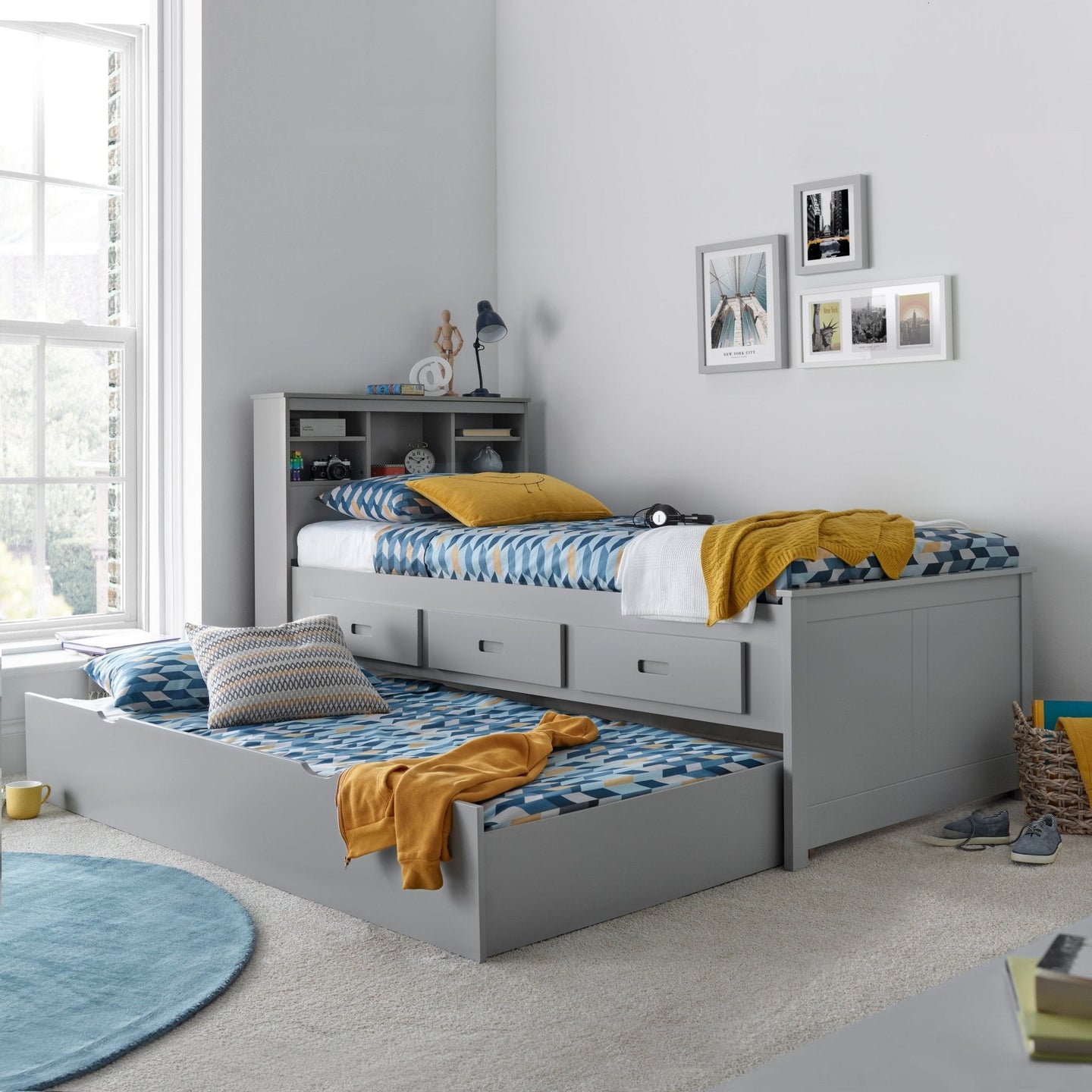 Veera Guest Bed with trundle in modern bedroom, featuring shelves and storage drawers.