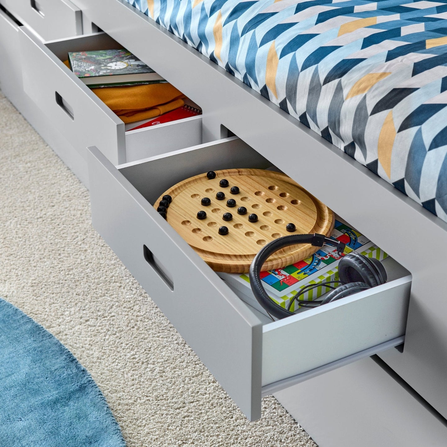 Modern guest bed with trundle option and storage drawers, featuring a stylish design ideal for versatile room organization.