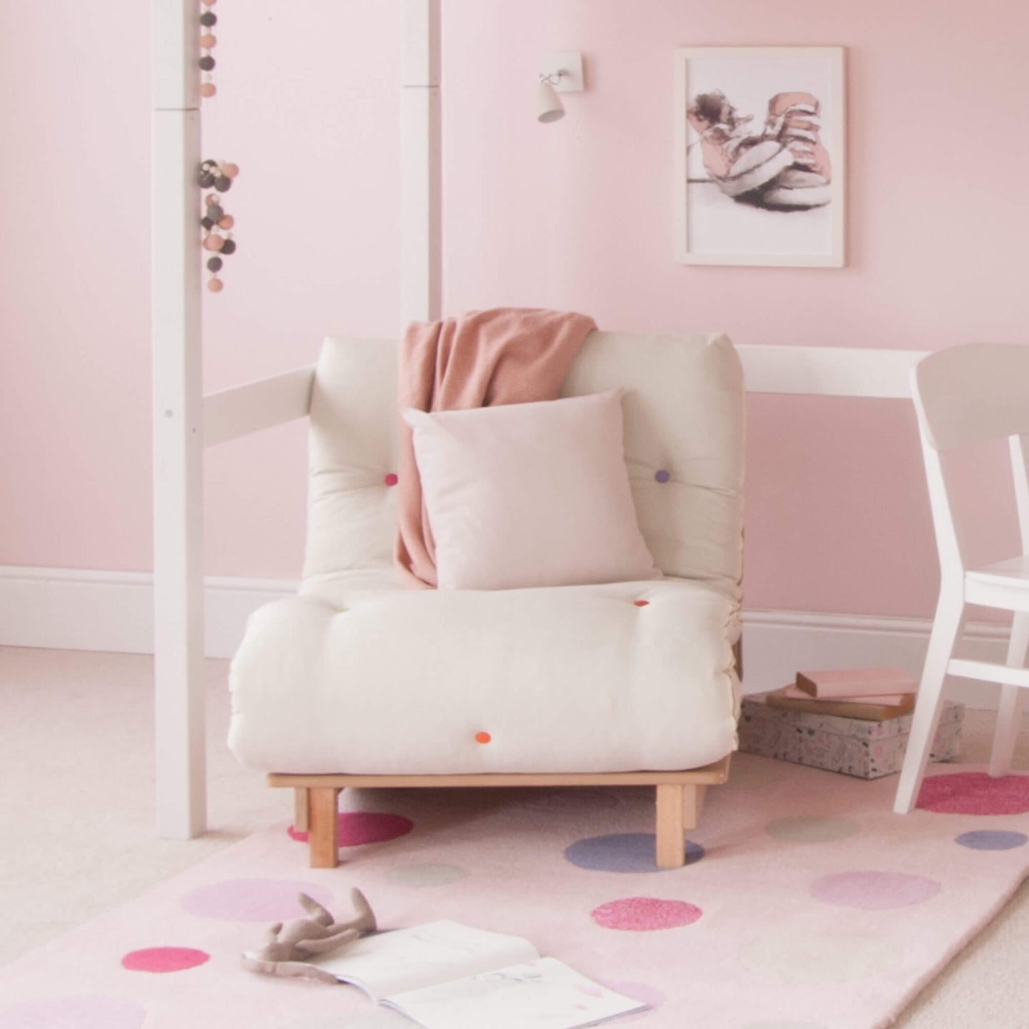 Classic Beech High Sleeper Bed with cream futon chair and mixed colored buttons in a pink-themed room.