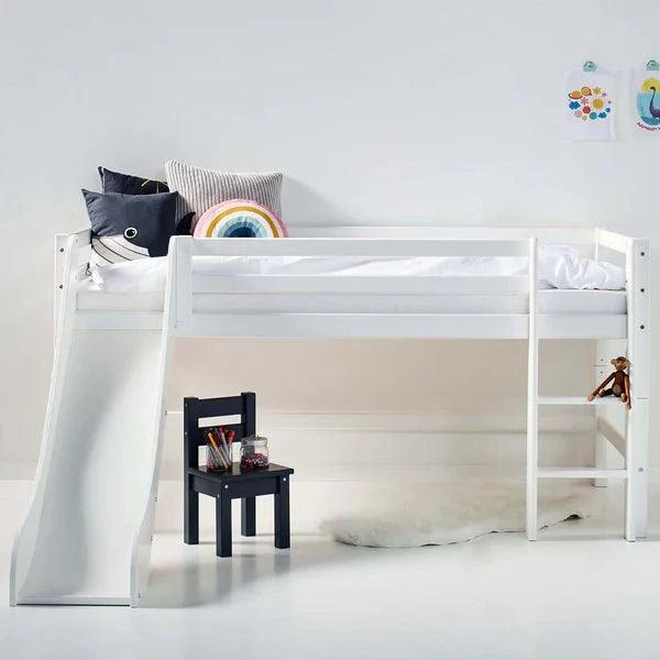 ECO Dream mid sleeper bed with slide by Hoppekids in a children's room setting, featuring solid pine construction and versatile design with left or right attachment options for ladder and slide.