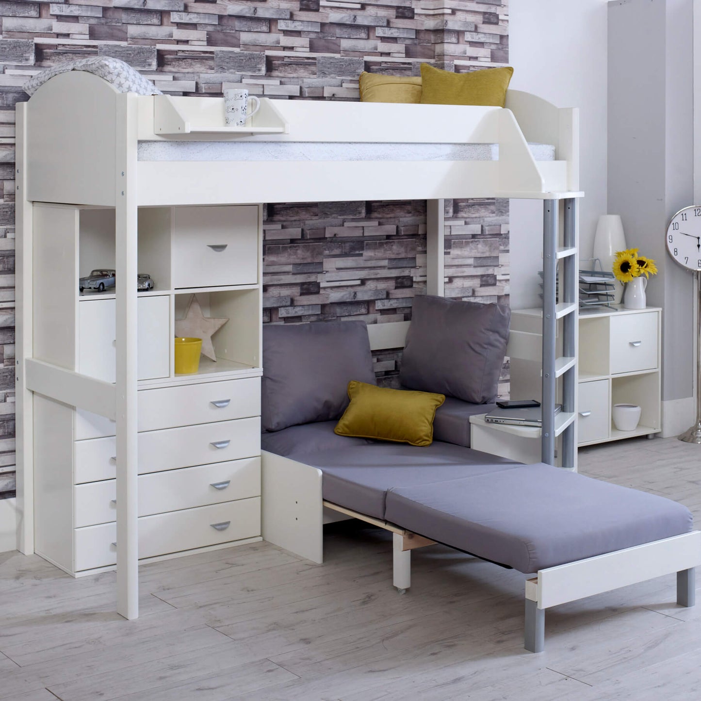 Noah high sleeper loft bed with pull-out chair bed and storage drawers in white, shown with accessories and wall decor.