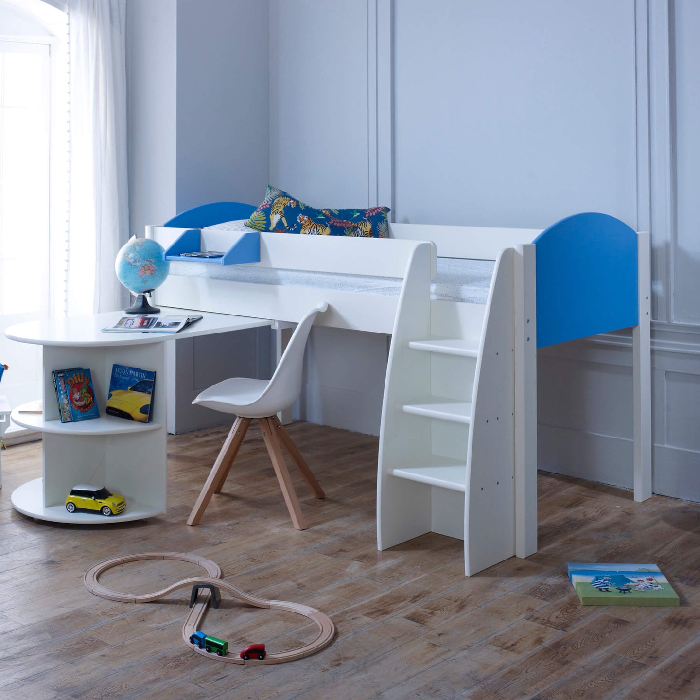 Mid Sleeper Bed with pull-out desk, storage shelves, and blue ends in a child's room.