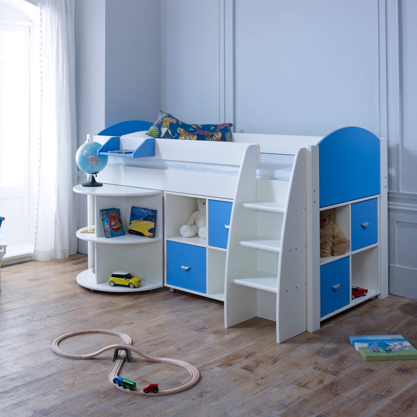 Mid Sleeper Bed with pull-out desk, storage shelves, and blue accents in a child's room.