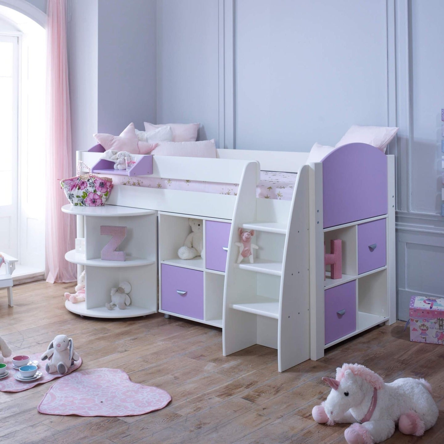 Mid Sleeper Bed with pull out desk, storage, and colorful accents in a child's room.