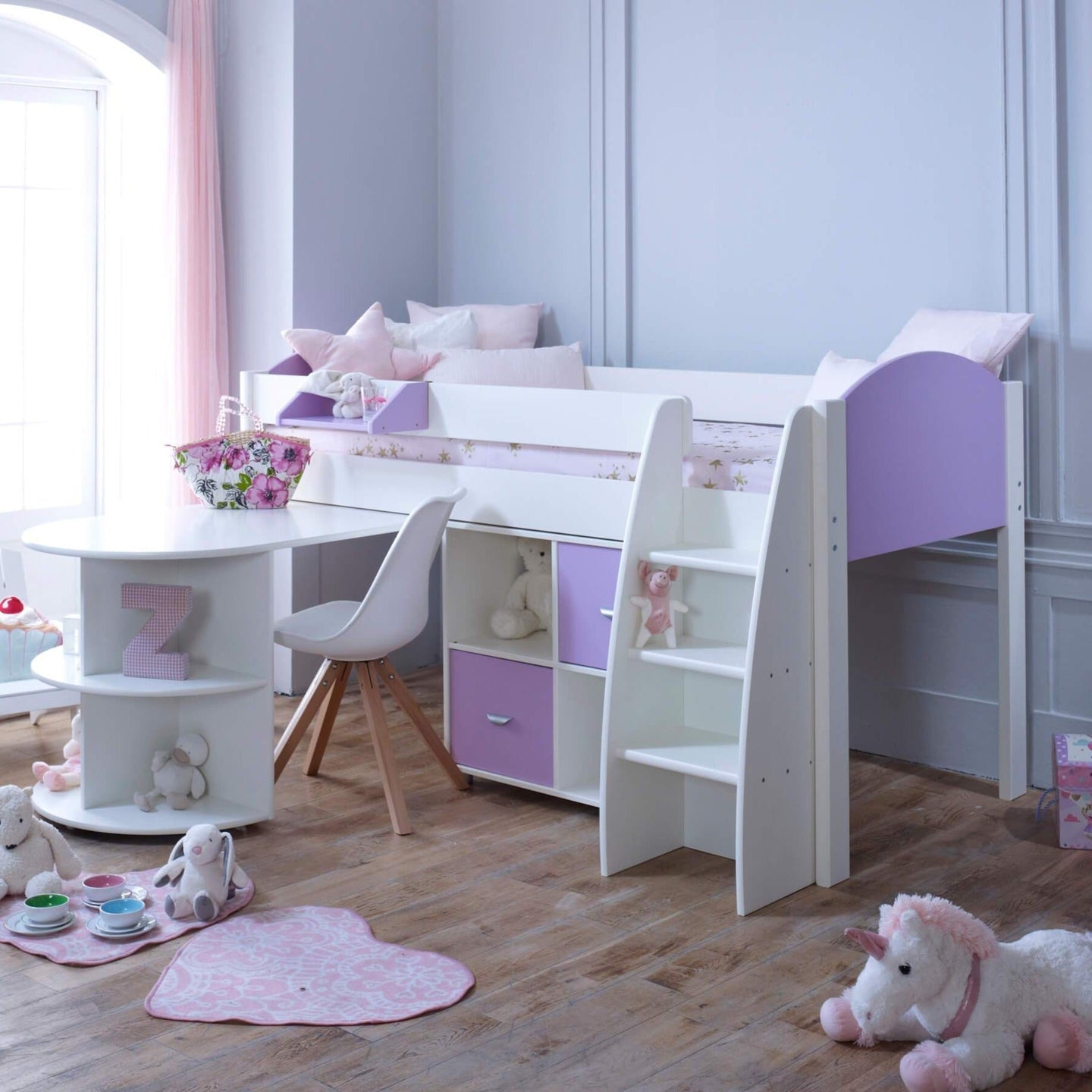 Mid Sleeper Bed with pull out desk, storage, and curved edge design in a child's room.