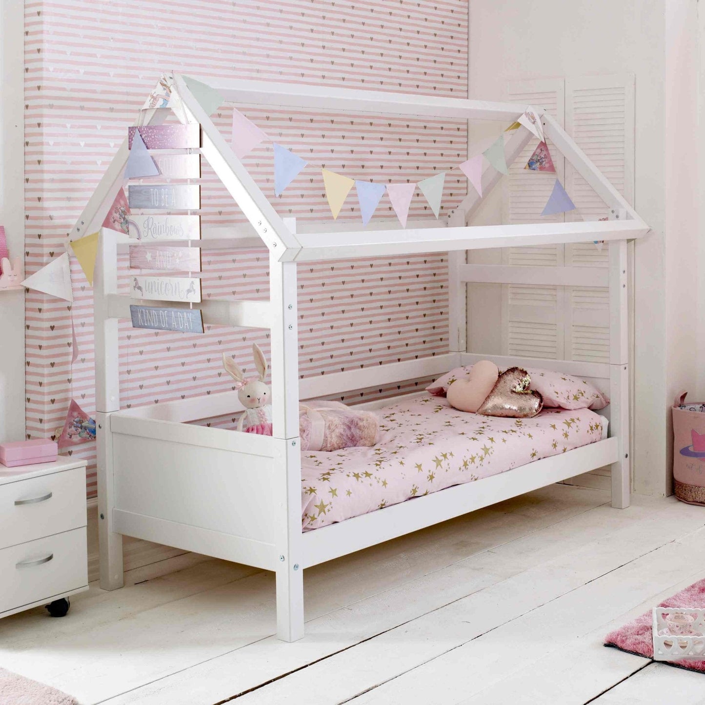 Nordic Playhouse Bed with Optional Trundle and Storage Drawers in a children's room with pastel decor.