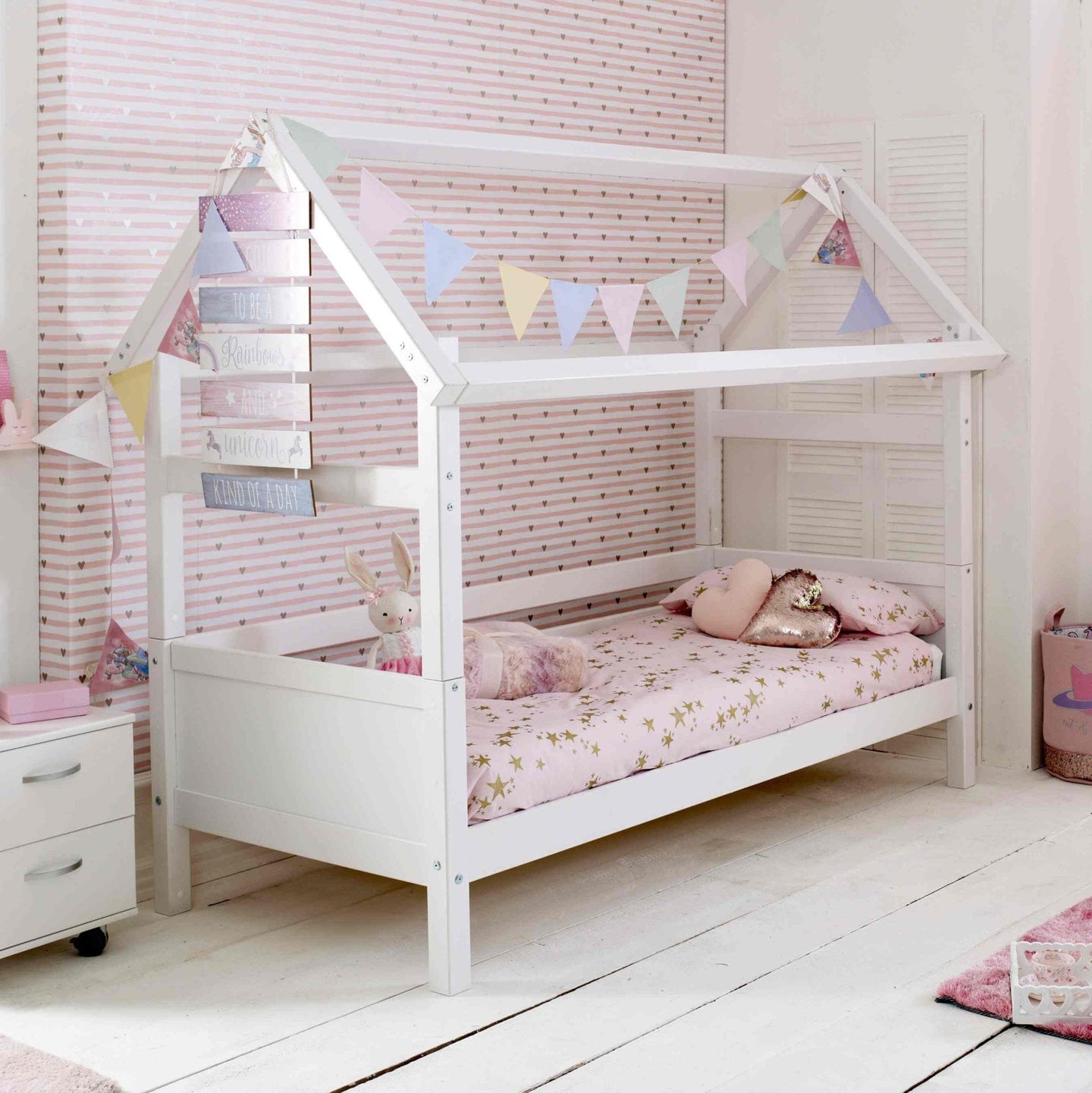 Nordic Playhouse Bed with Optional Trundle and Storage Drawers in a children's room with pastel decor.