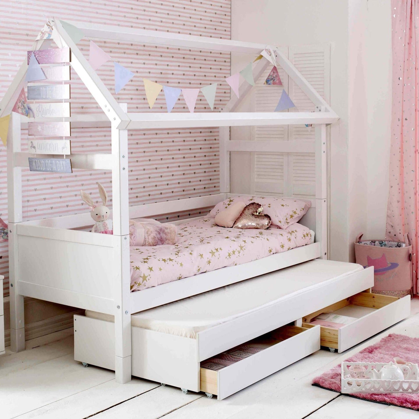 Nordic Playhouse bed with optional trundle and storage drawers in a stylish kids' bedroom.