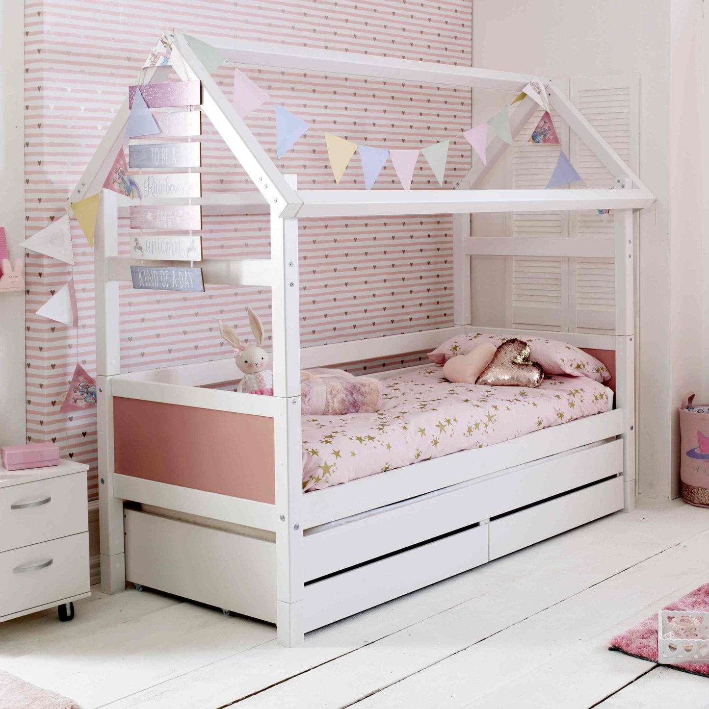 Nordic Playhouse bed for kids with optional trundle and storage drawers, white house design in bedroom setting.