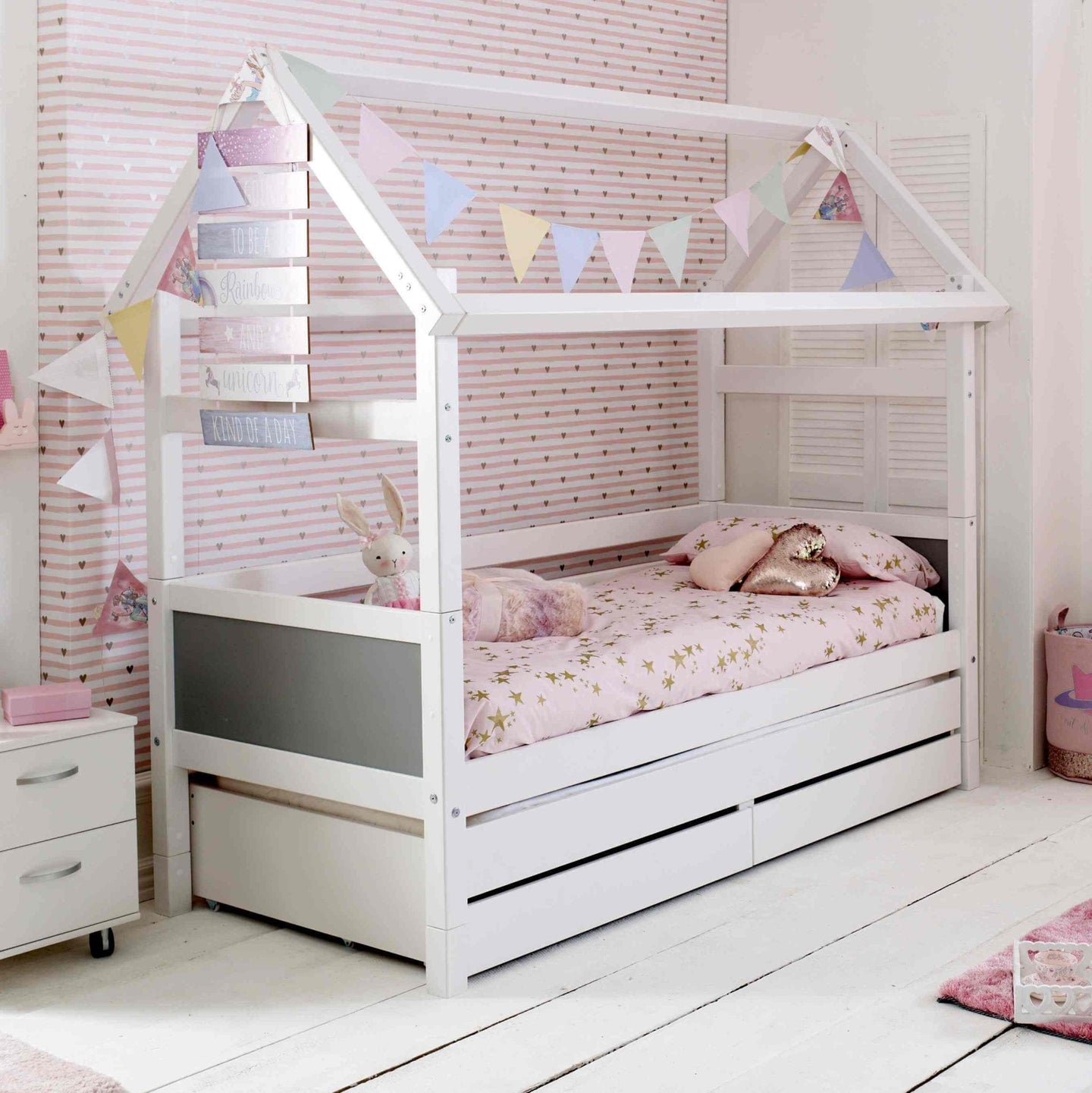 Nordic Playhouse Bed with optional trundle and storage drawers, kids' bed with house structure, white Scandinavian pine, colorful decor.