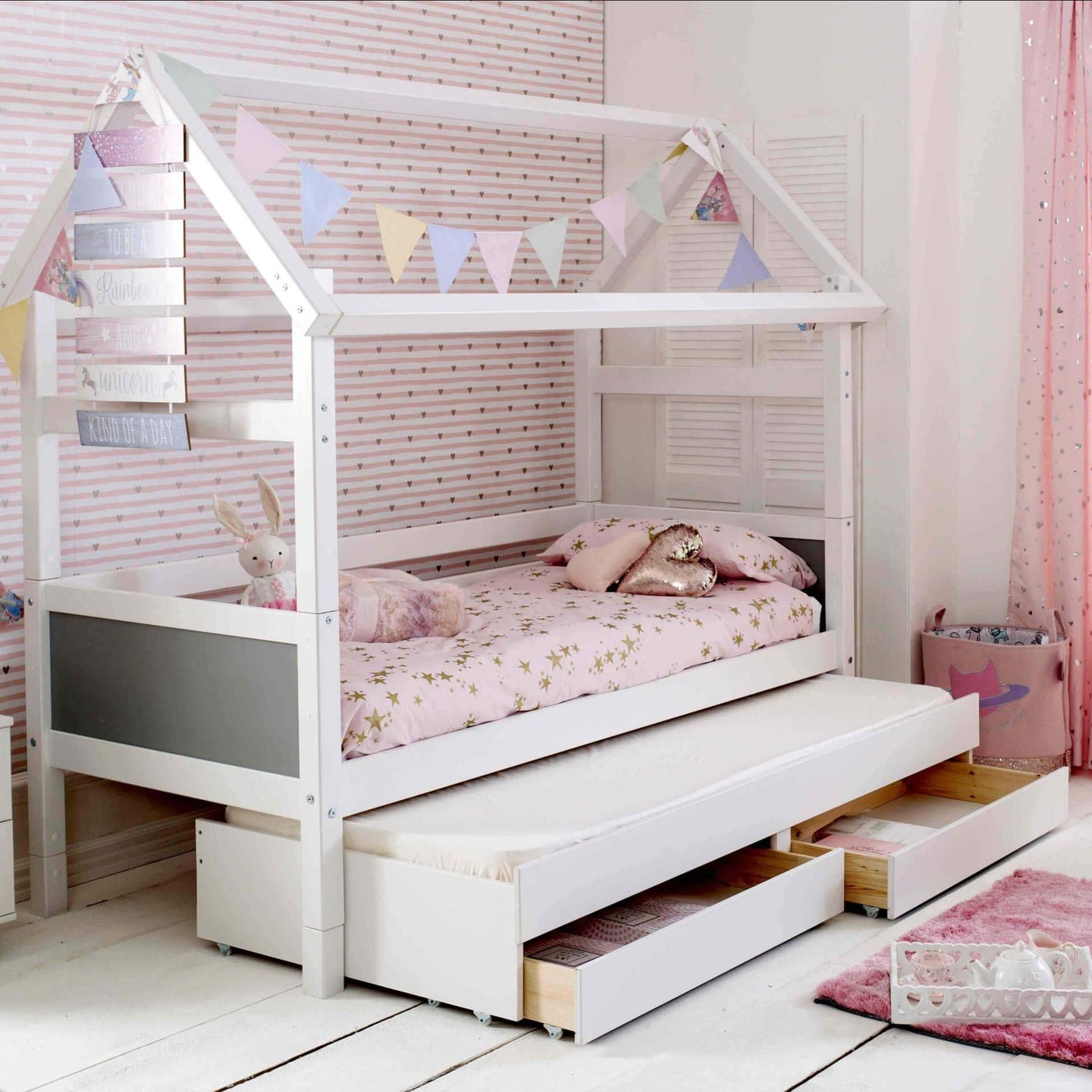 Nordic Playhouse Bed with optional trundle and storage drawers in children's room.