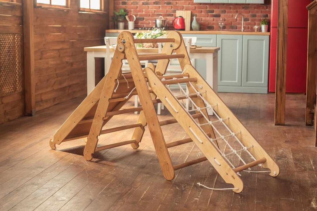 Pikler Montessori Climber Ladder Slide in a wooden kitchen setting, featuring adjustable height, customizable playground design, and ramp slide with climbing net for indoor or outdoor use.