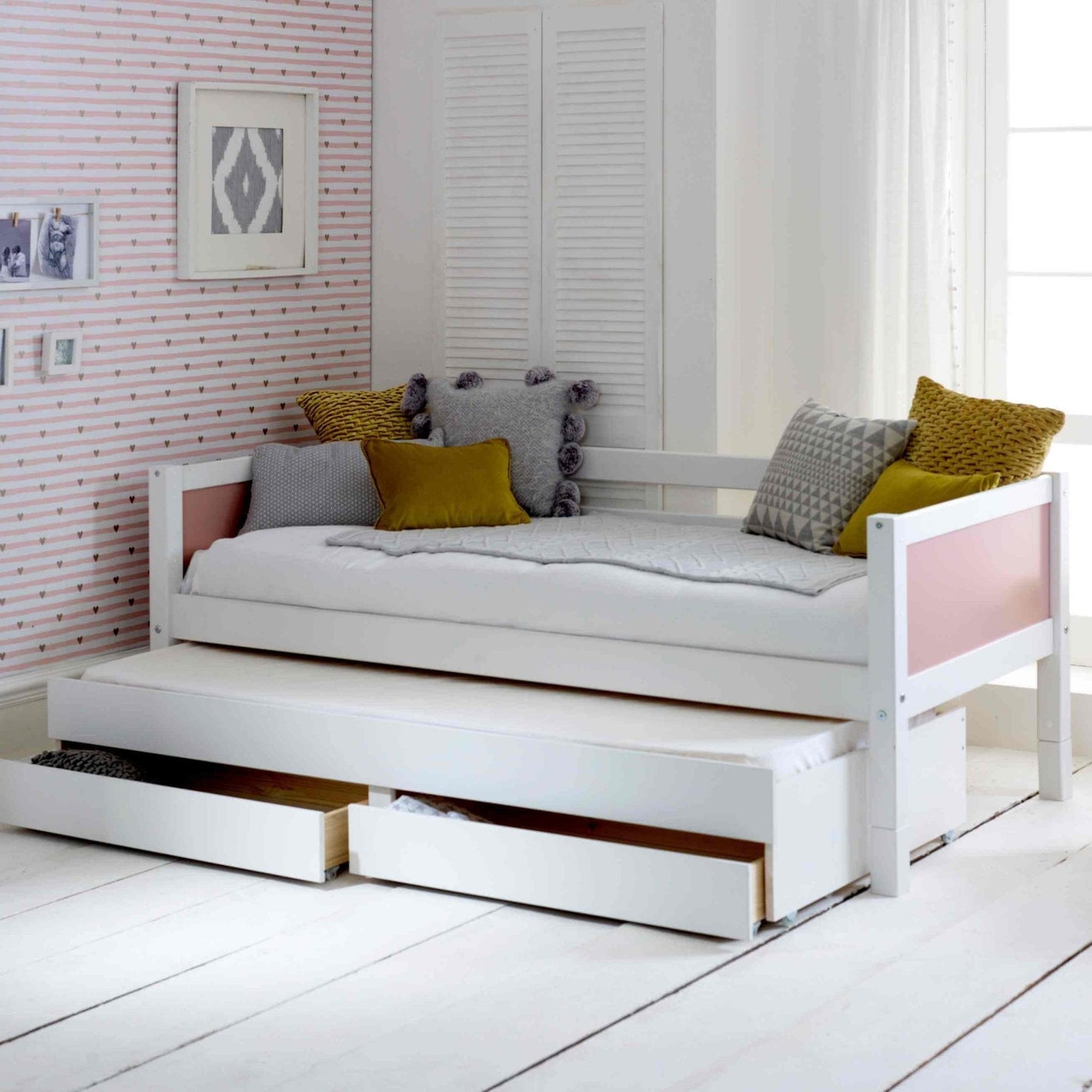 Nordic daybed with trundle and storage drawers in a stylish white design.