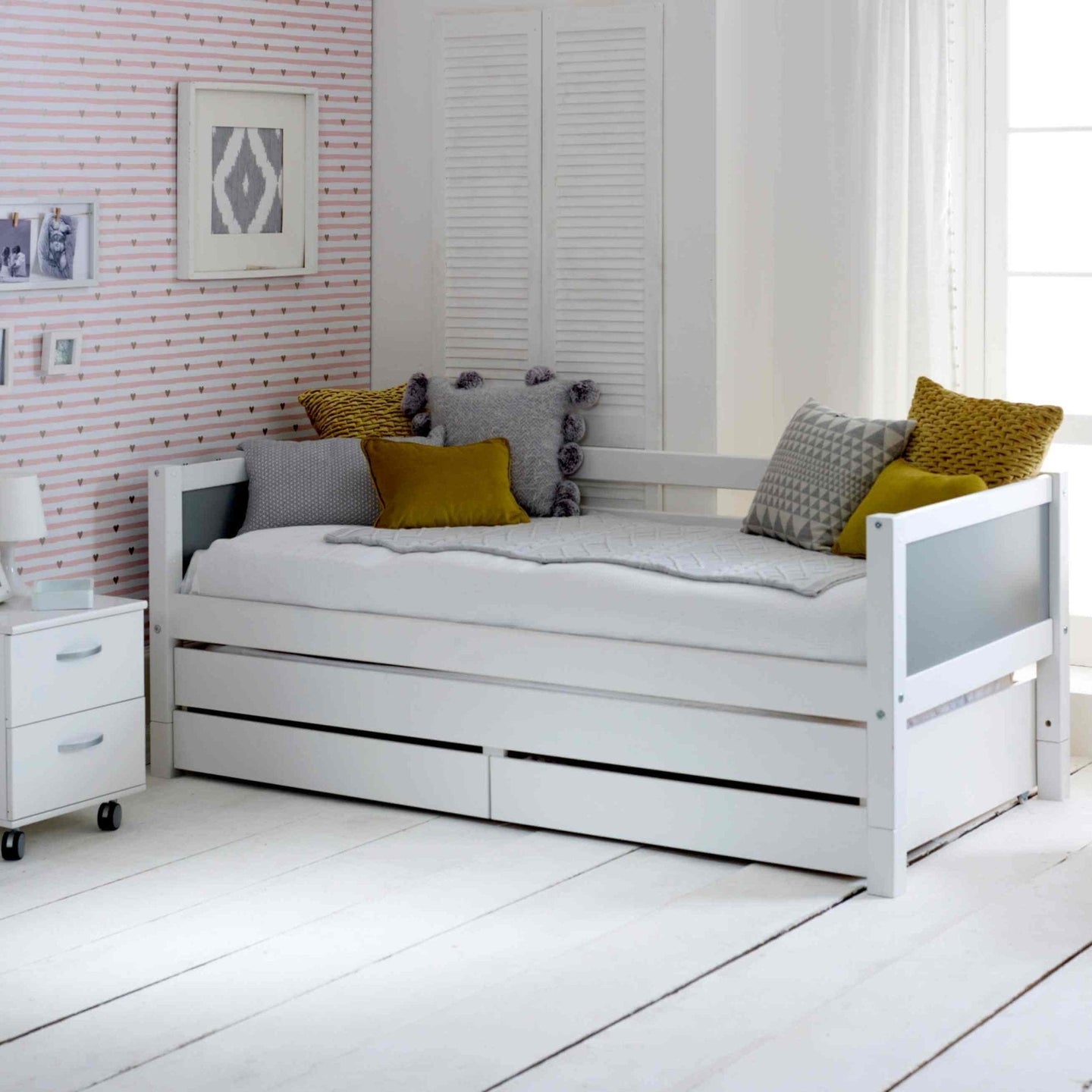 Nordic Daybed with trundle pull out bed and storage drawers in a modern bedroom setting.